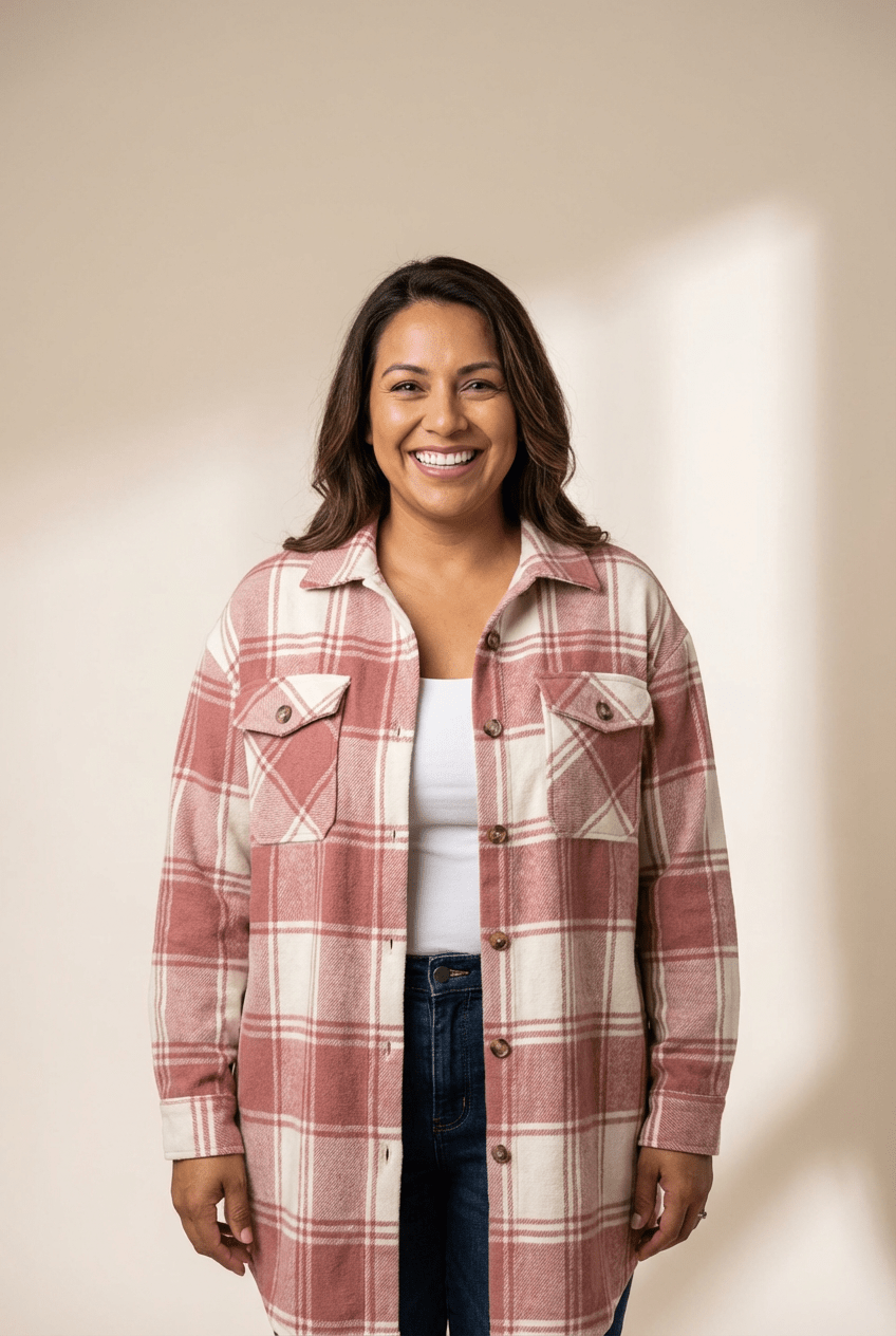 Woman wearing a plaid shirt against a plain background