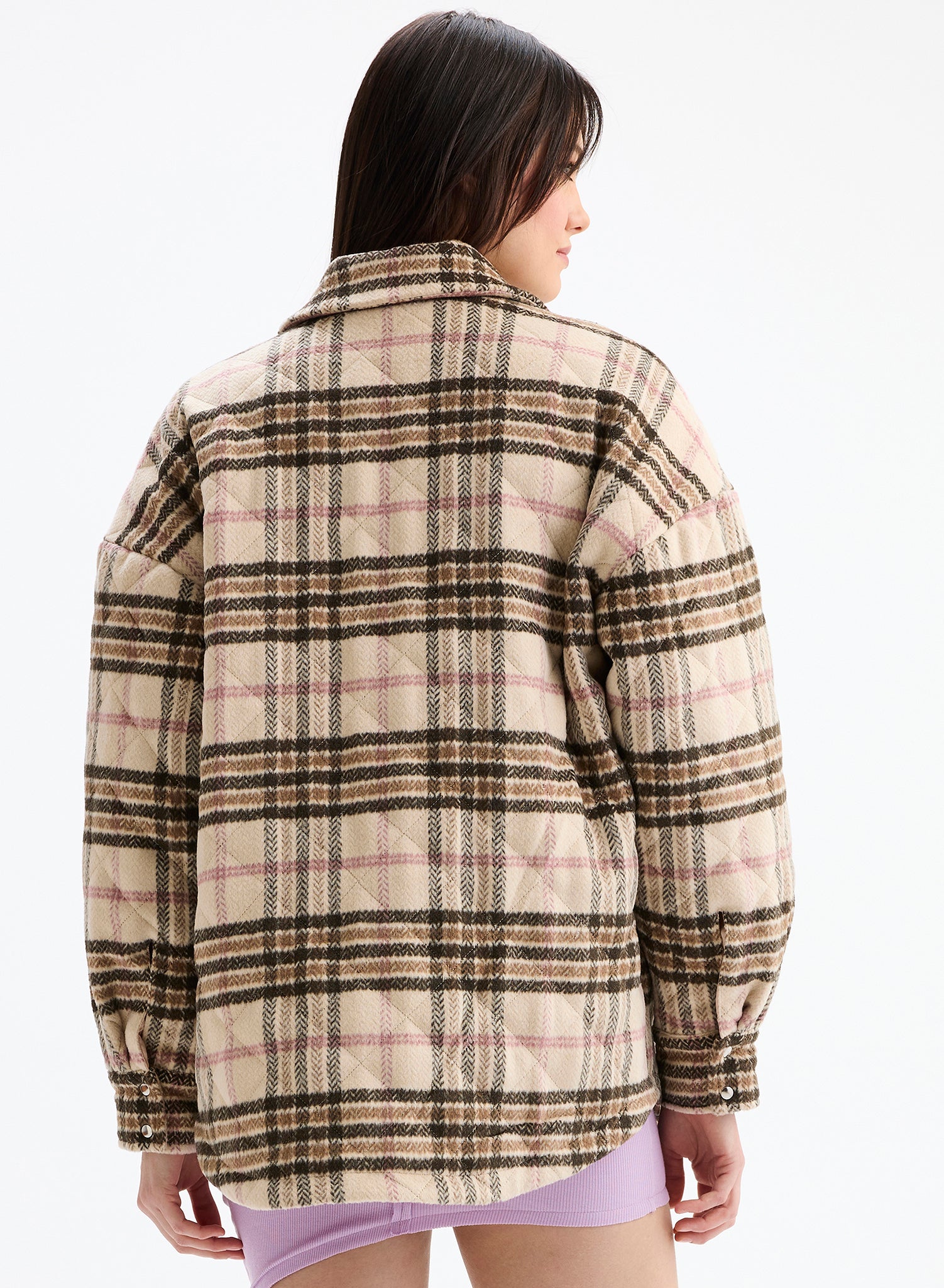 Person wearing a plaid shirt on a white background