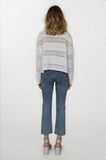 Person wearing a striped sweater and blue jeans on a white background