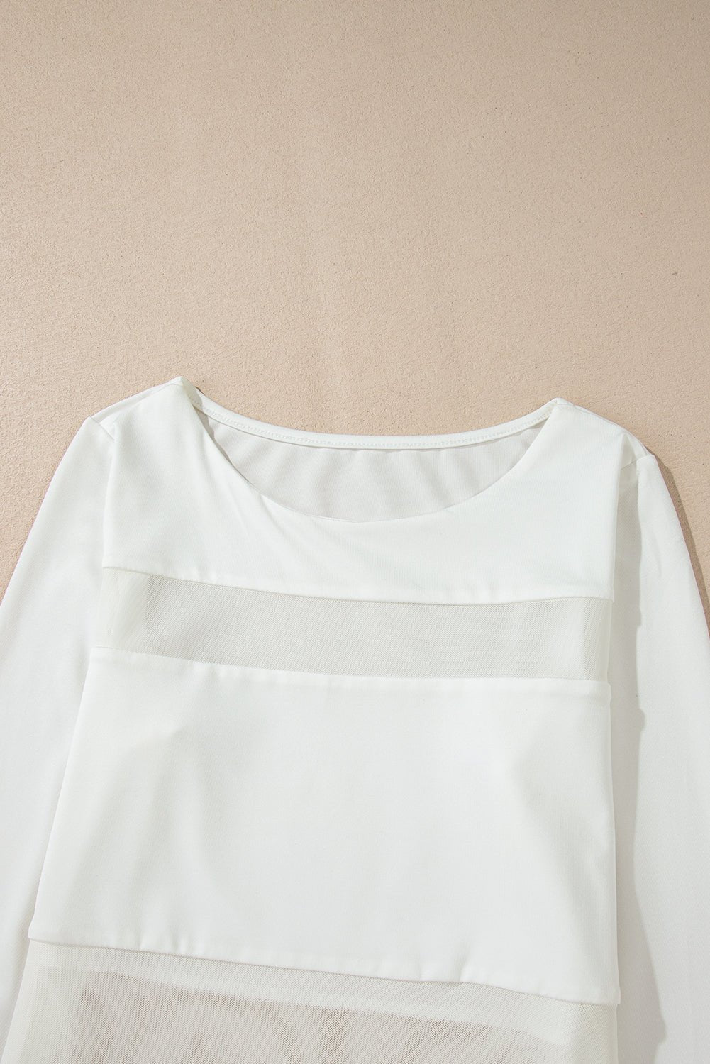 White long-sleeve shirt on a beige background