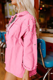 Person wearing a pink jacket with decorative elements in an indoor setting