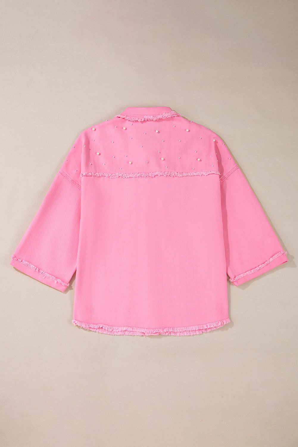 Pink denim jacket on a beige background