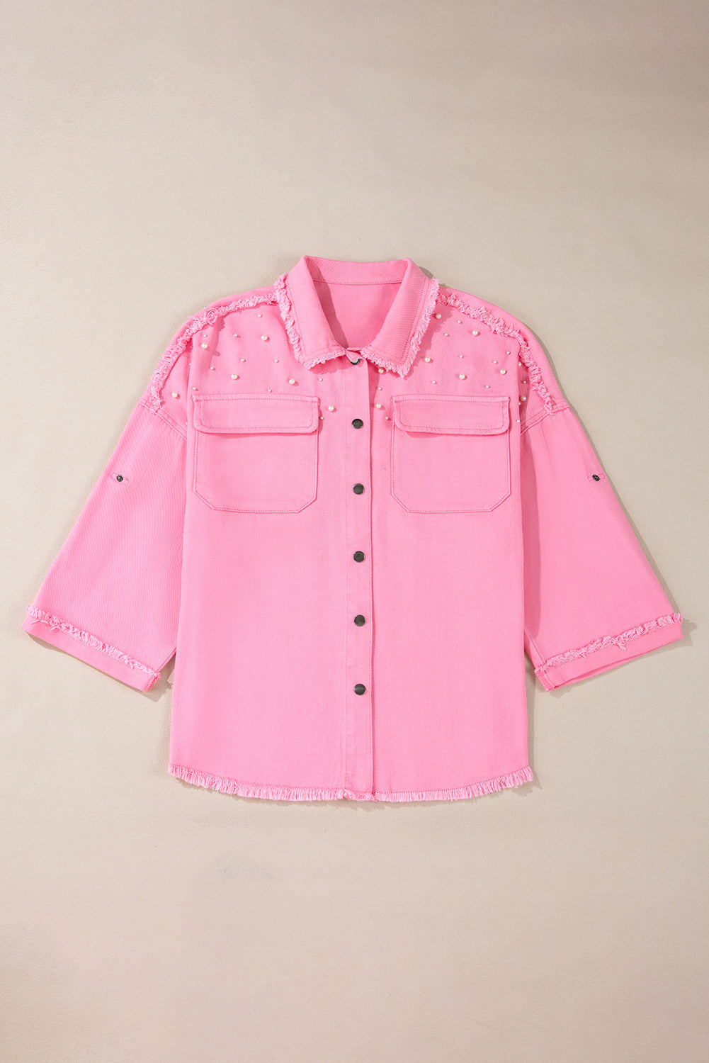 Pink denim jacket on a beige background