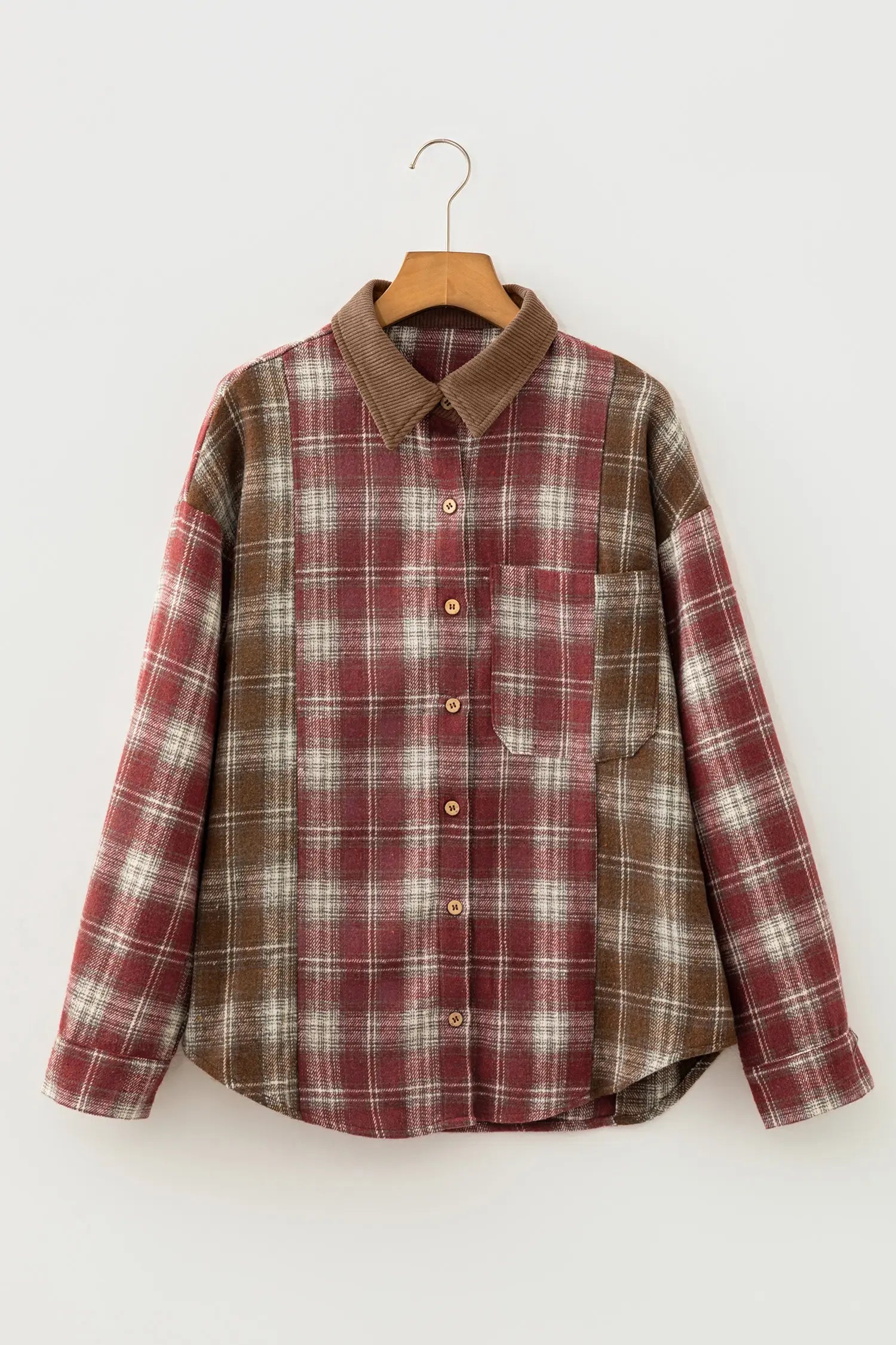 Plaid shirt with brown collar on a hanger against a white background
