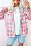 Person wearing a pink plaid shirt over a white top with light blue jeans on a white background
