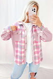Person wearing a pink plaid shirt with a white background