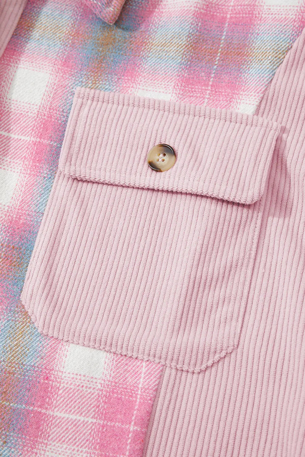 Close-up of a pink corduroy pocket on a plaid fabric background