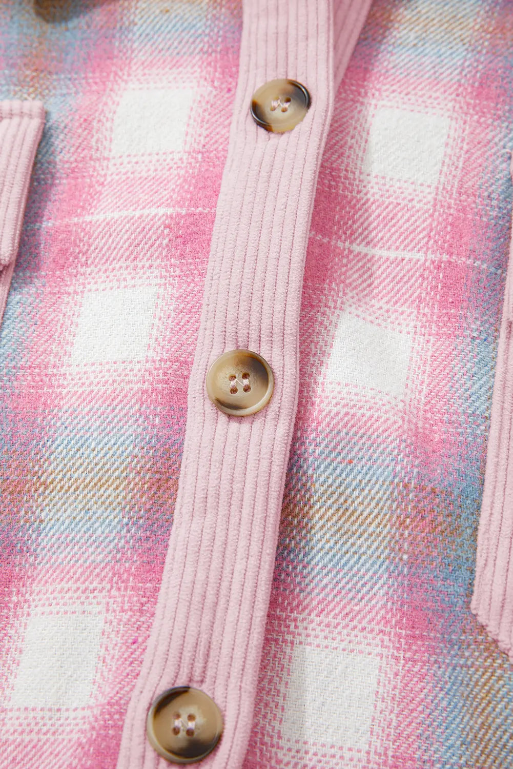Close-up of a pink plaid shirt with buttons on a multicolored checkered background