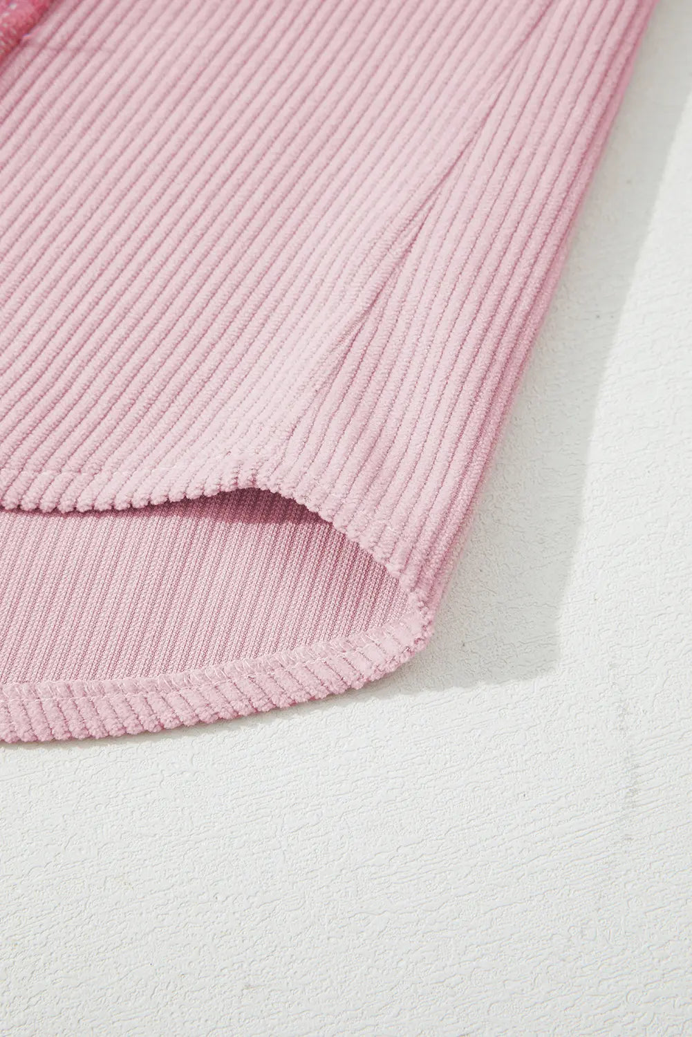 Pink textured fabric on a light gray background