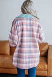 Person wearing a plaid shirt in a living room setting