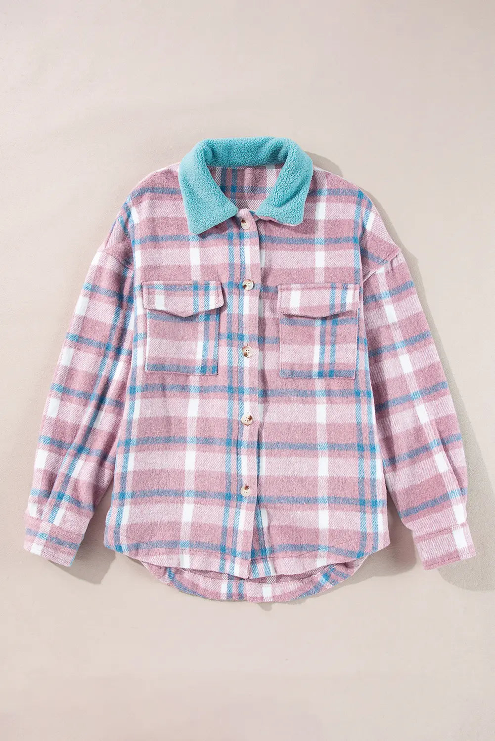 A pink and blue plaid button-up flannel shirt with a contrasting light blue fleece collar, laid flat on a beige background.