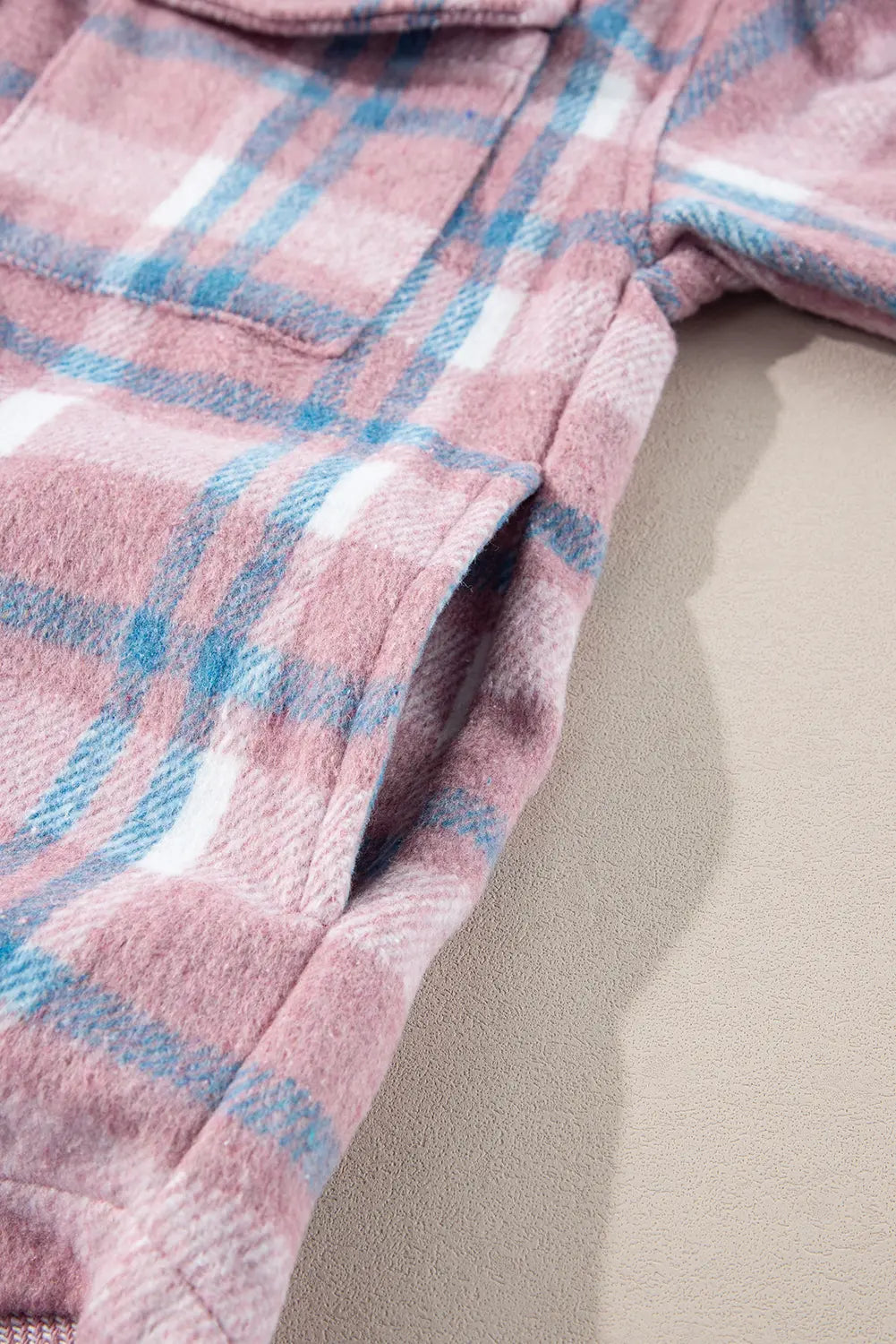 Close-up of a pink and blue plaid fabric texture