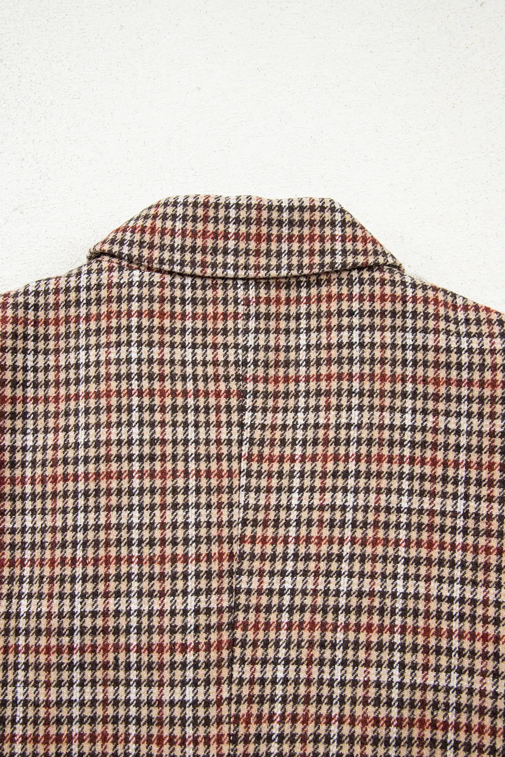 Close-up of a checkered shirt with a collar on a white background