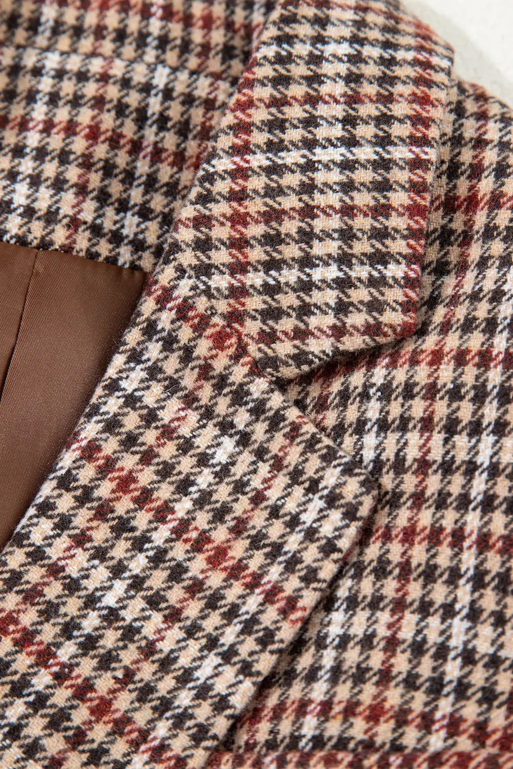 Close-up of a houndstooth patterned fabric with a collar.