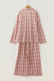 Dusty pink and brown plaid pajama set on a wooden hanger.