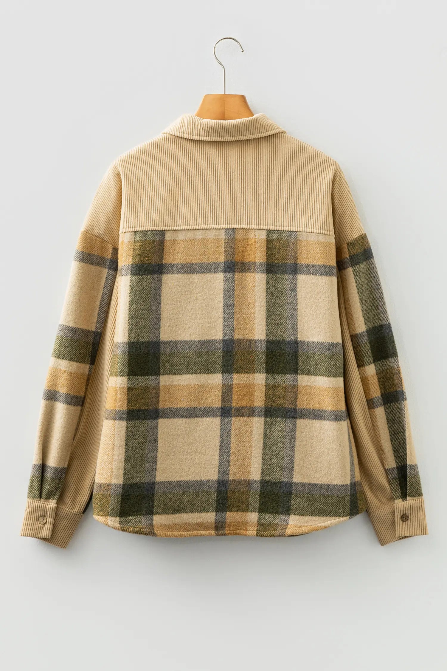 Beige flannel shirt with plaid pattern on a hanger against a white background
