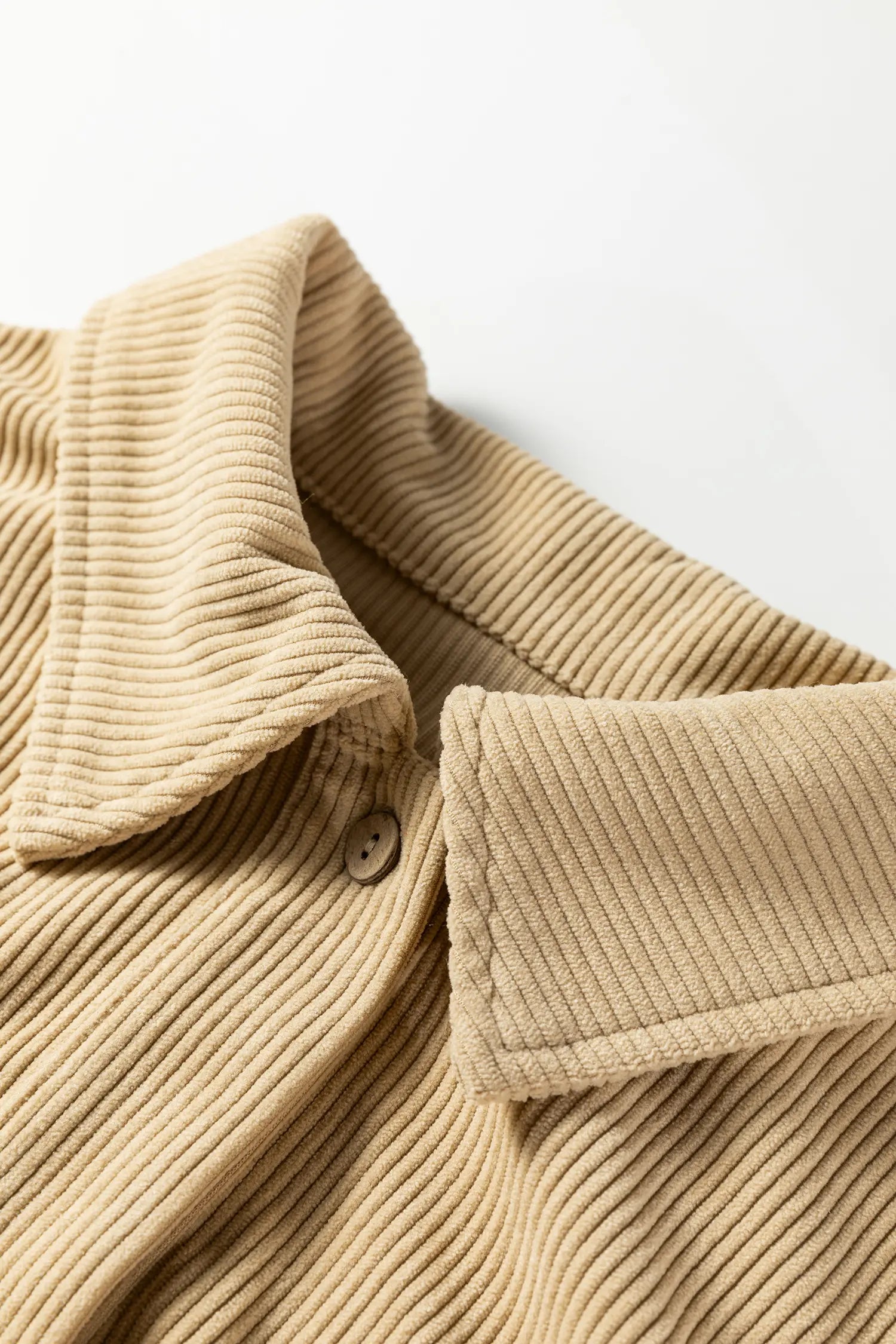Close-up of a beige corduroy jacket on a light background
