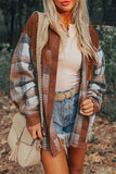 Woman wearing a plaid cardigan, white top, denim shorts, and beige purse outdoors.