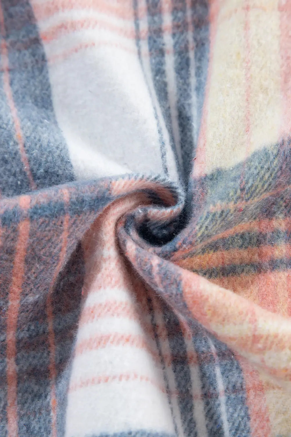 Close-up of plaid fabric with a focus on texture and pattern.