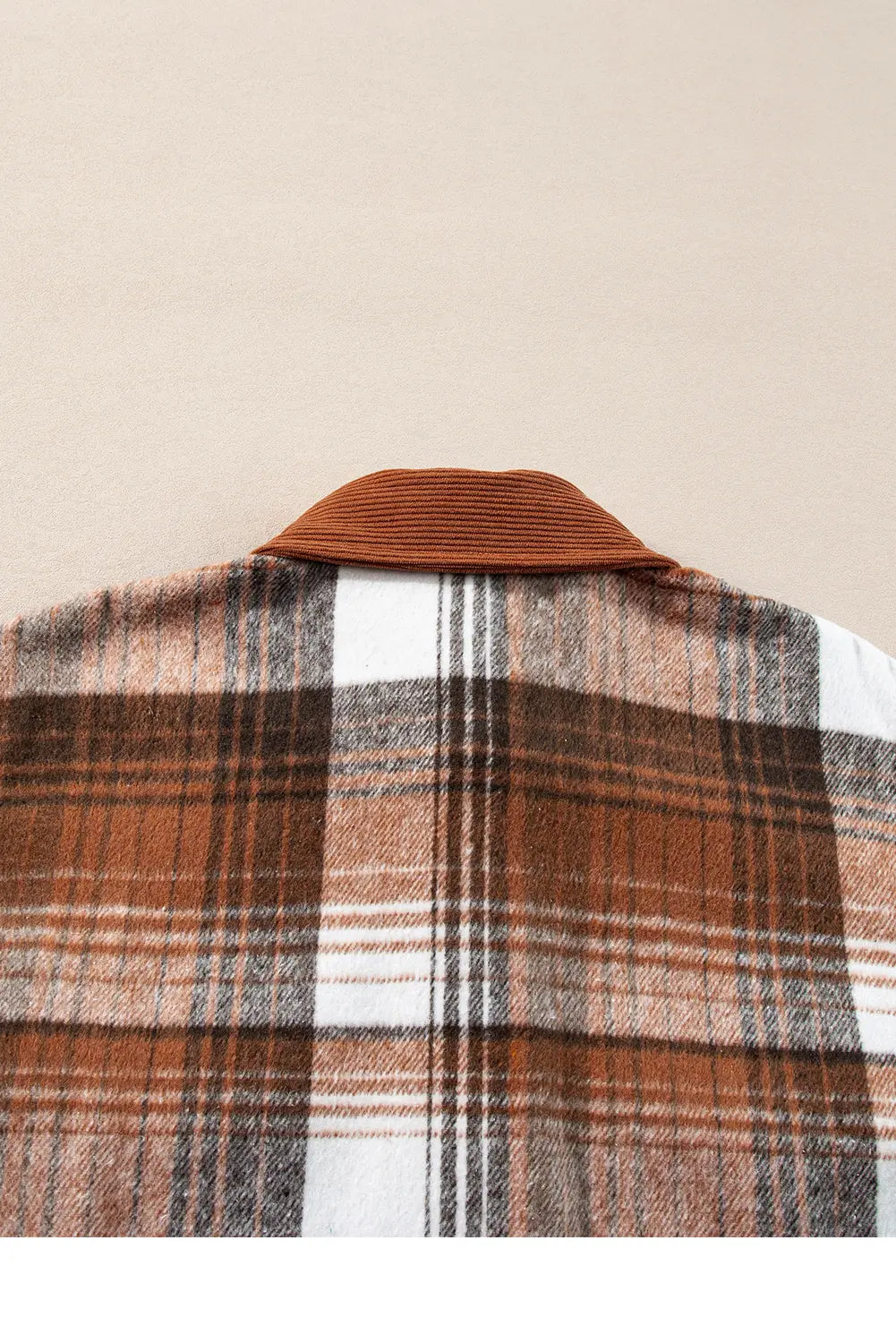 Plaid shirt with a brown collar on a beige background