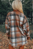 Person wearing a plaid shawl in a forest setting