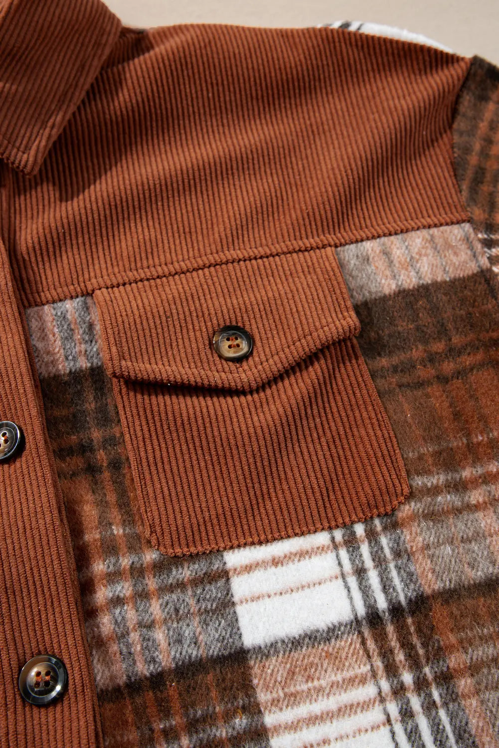 Close-up of a brown corduroy jacket with plaid pattern