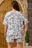 Person wearing a camouflage outfit standing in front of a stone archway.