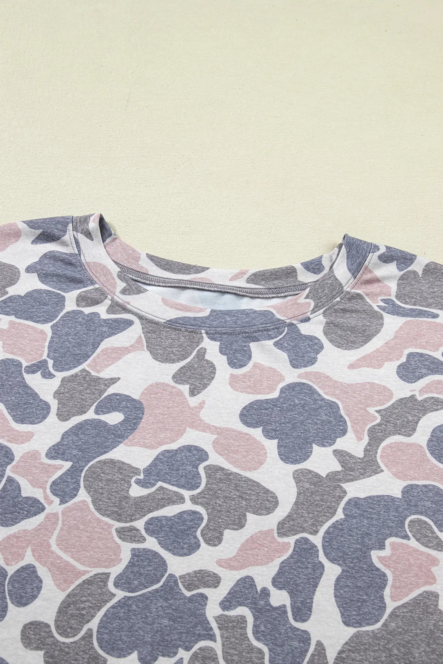 Camouflage-patterned shirt on a beige background
