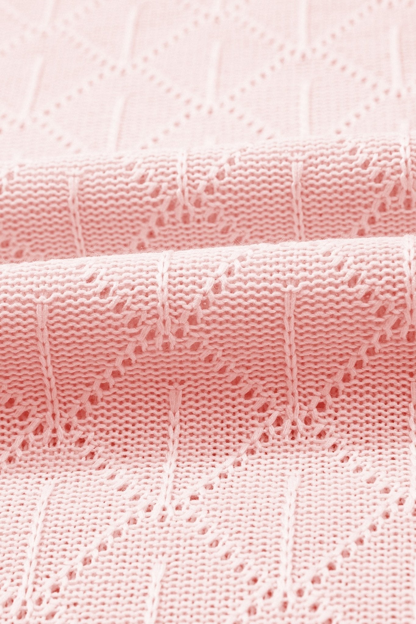 Close-up of pink textured fabric with a subtle pattern