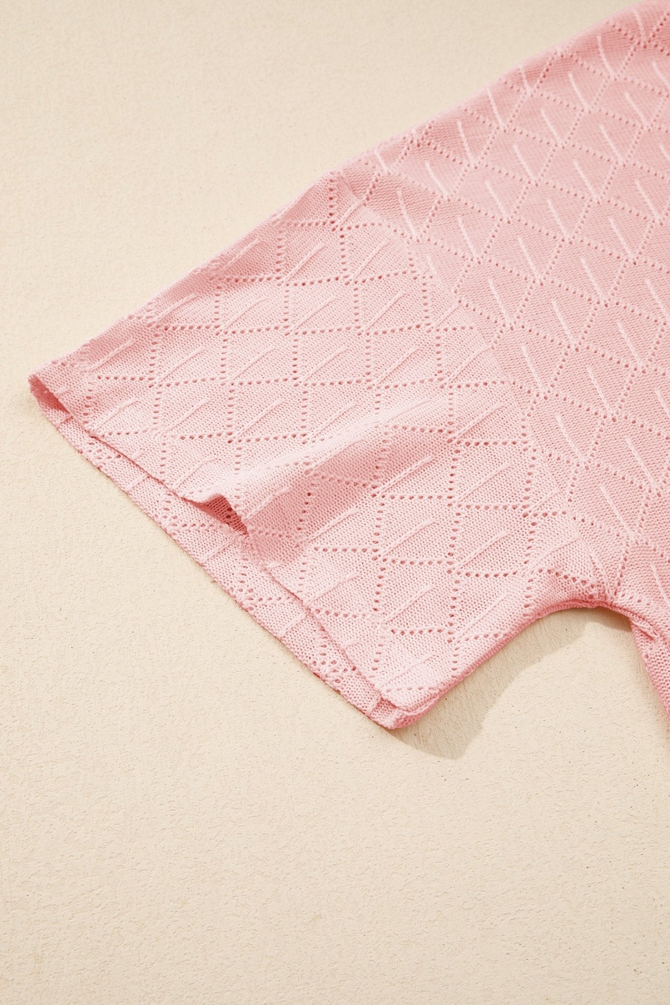 Close-up of a pink quilted fabric on a beige background