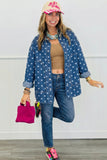 Woman modeling blue polka-dot denim shirt jacket with tan tank, blue jeans, pink cap, handbag, and sneakers.