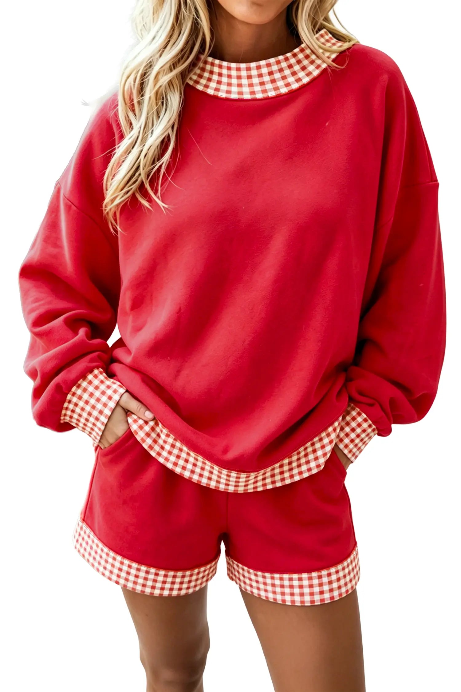 A woman wearing a red two-piece lounge set with red and white gingham trim on the collar, cuffs, and hem, shown against a plain white background.