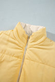 Close-up of pale yellow puffer jacket with high collar and beige zipper on a light blue-gray background.