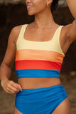 Woman wearing a colorful striped bikini with a blurred natural background