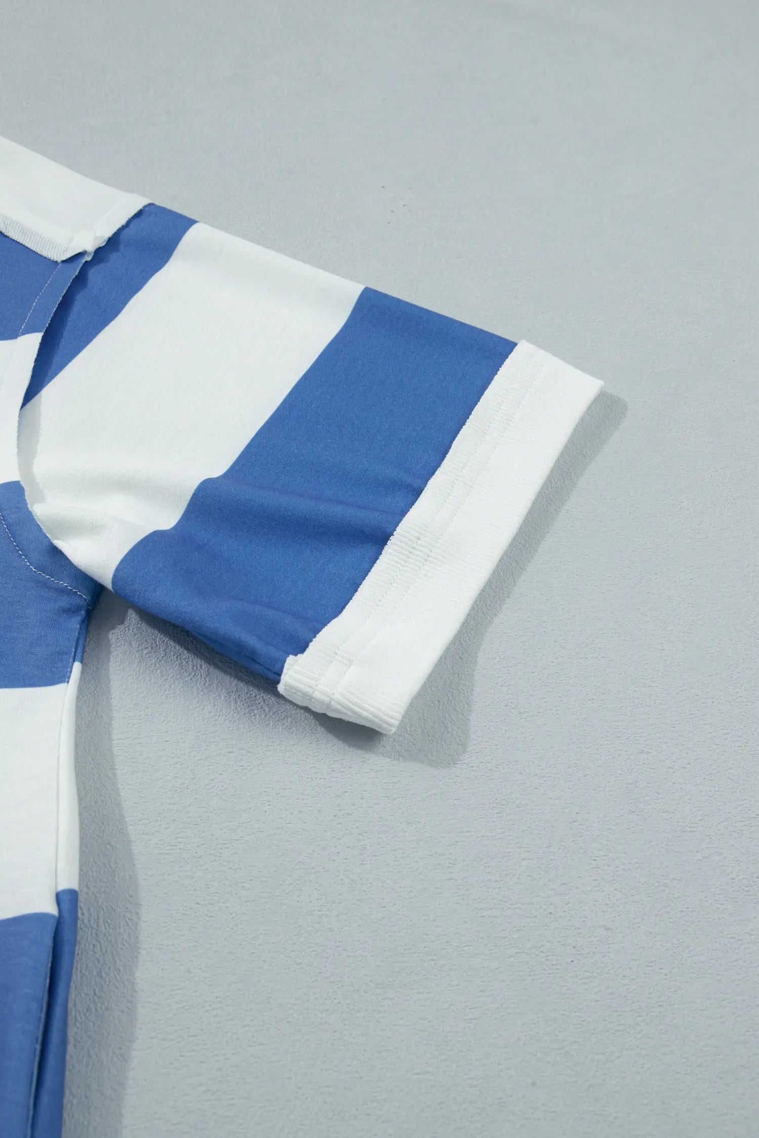 Close-up of a blue and white striped fabric on a gray background
