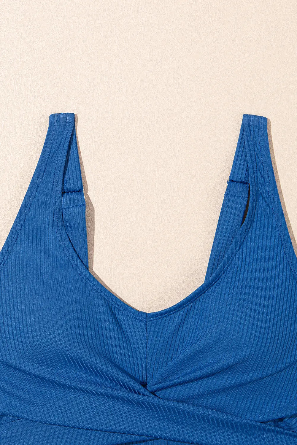 Blue ribbed top on a beige background