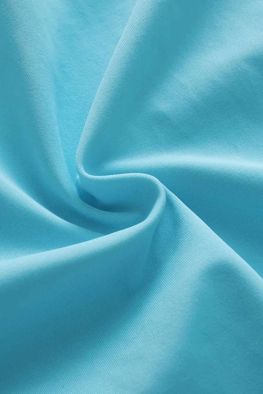 Close-up of blue fabric with folds