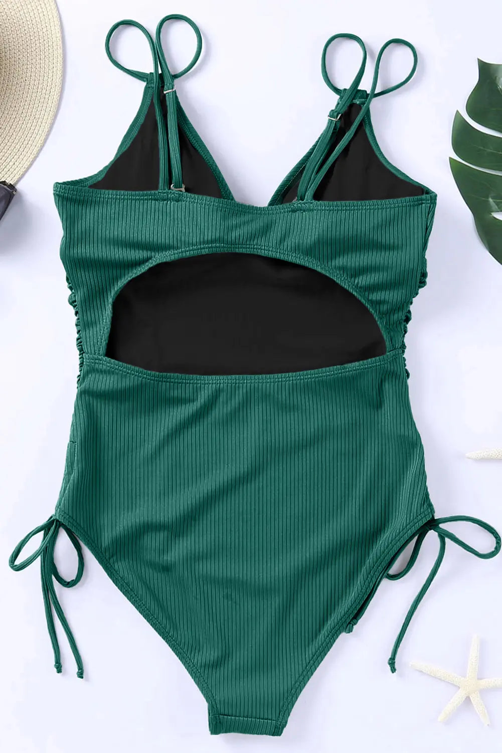 Green ribbed swimsuit with black lining on a white background