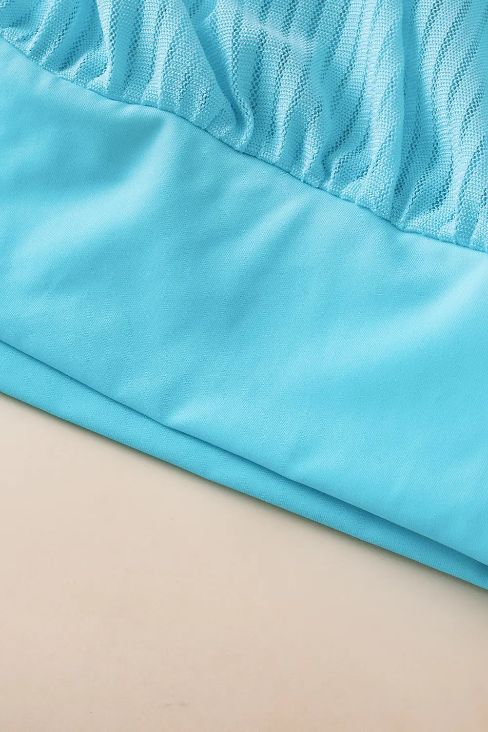 Close-up of blue fabric on a beige background