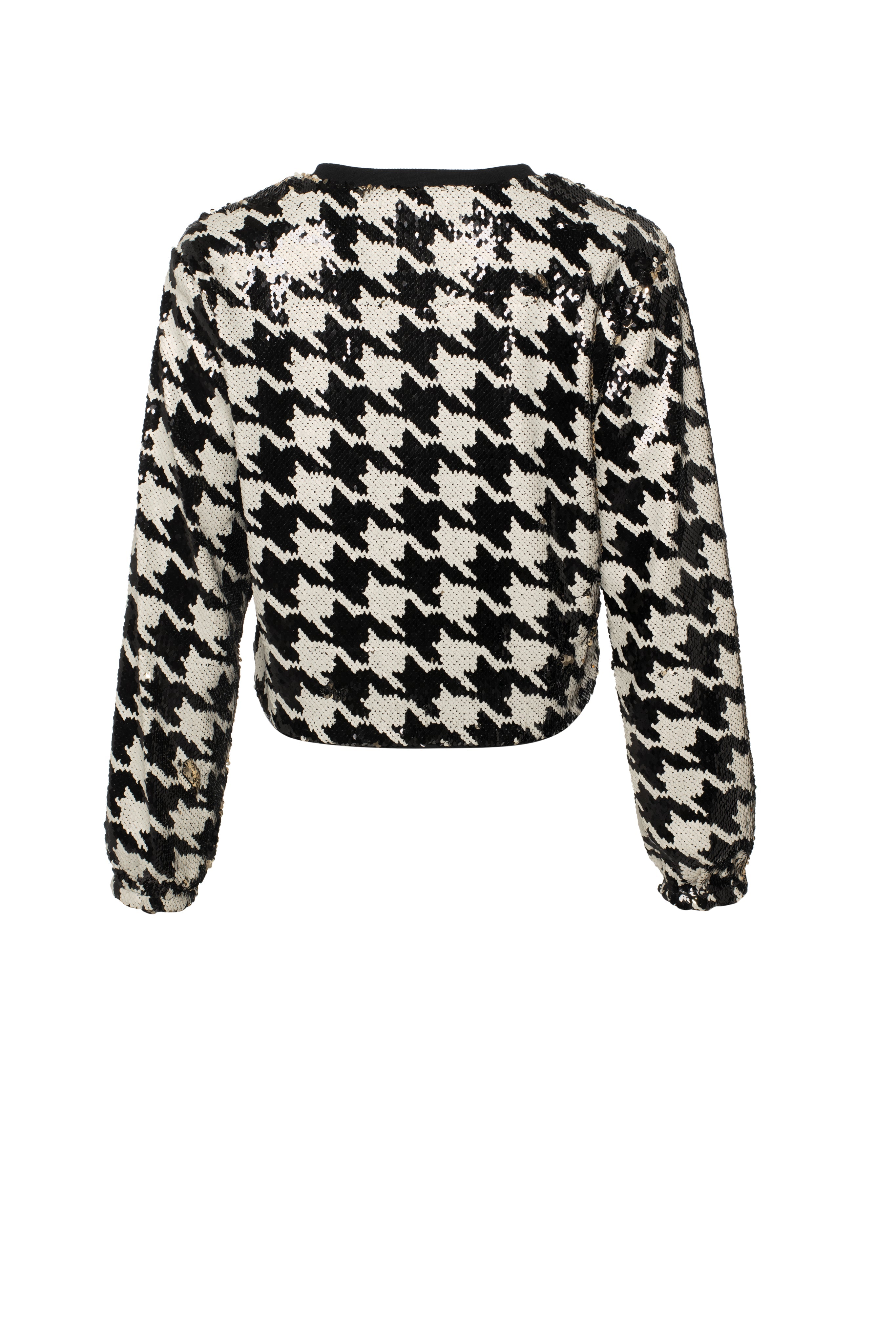 Black and white houndstooth patterned sweater on a white background