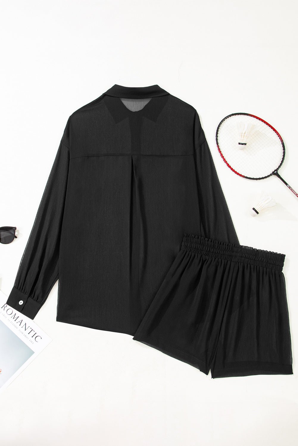 Black outfit with long-sleeve top and shorts on a white background