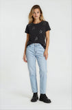 Woman wearing a black t-shirt with star patterns and light blue jeans on a white background