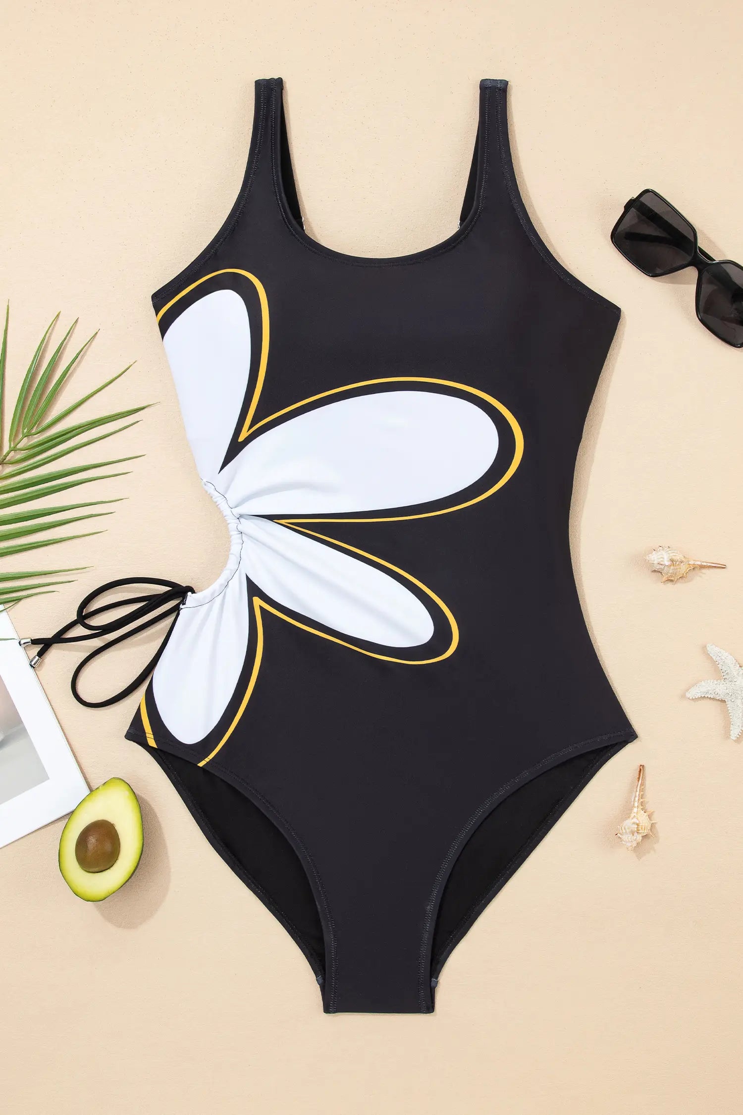 Black swimsuit with butterfly design on a beige background