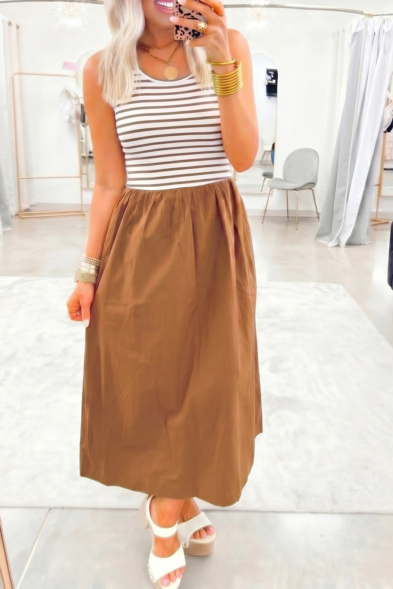 Woman wearing a striped top and brown skirt in a store setting