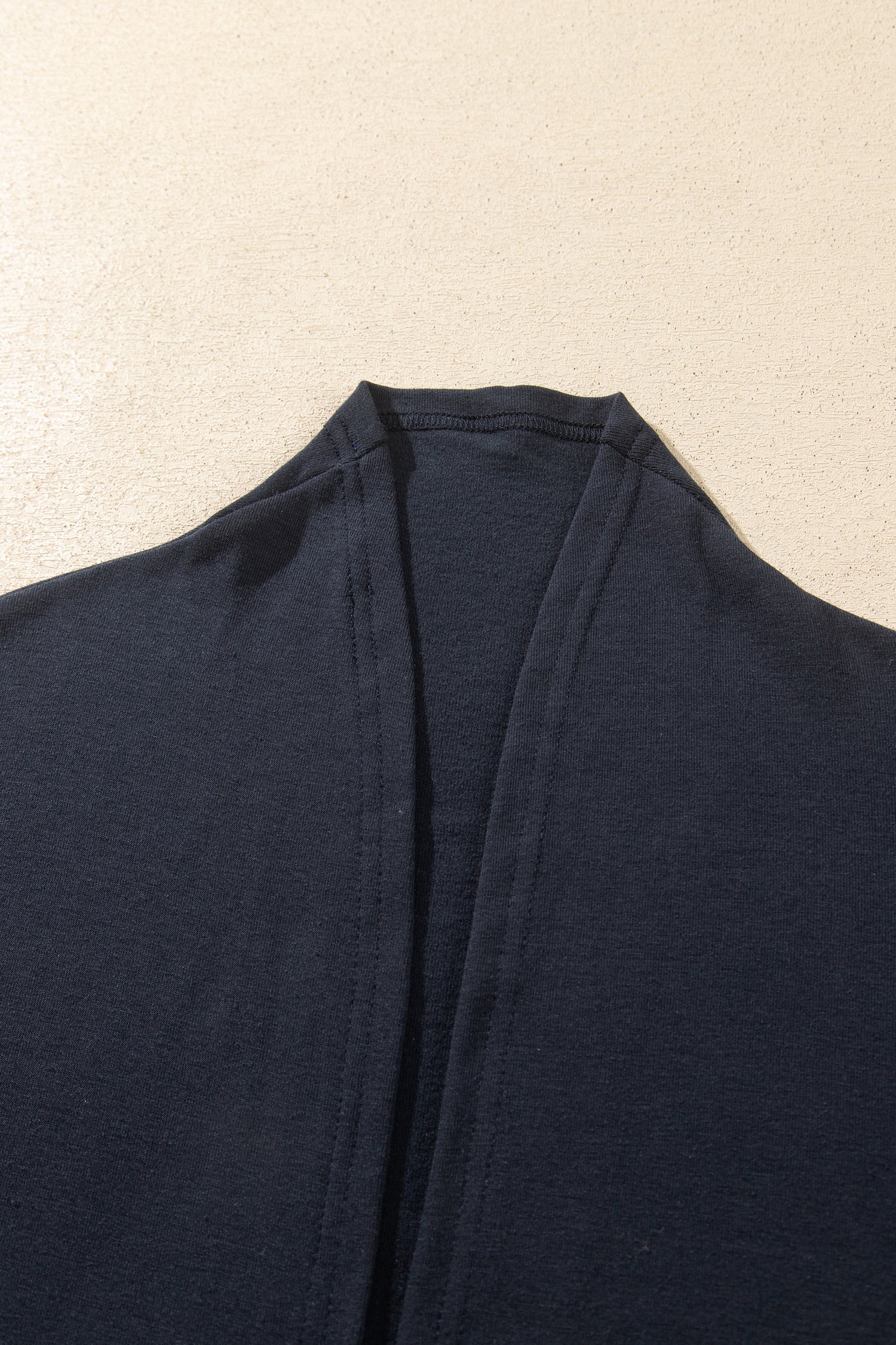 Close-up of a dark navy blue garment laid flat against 