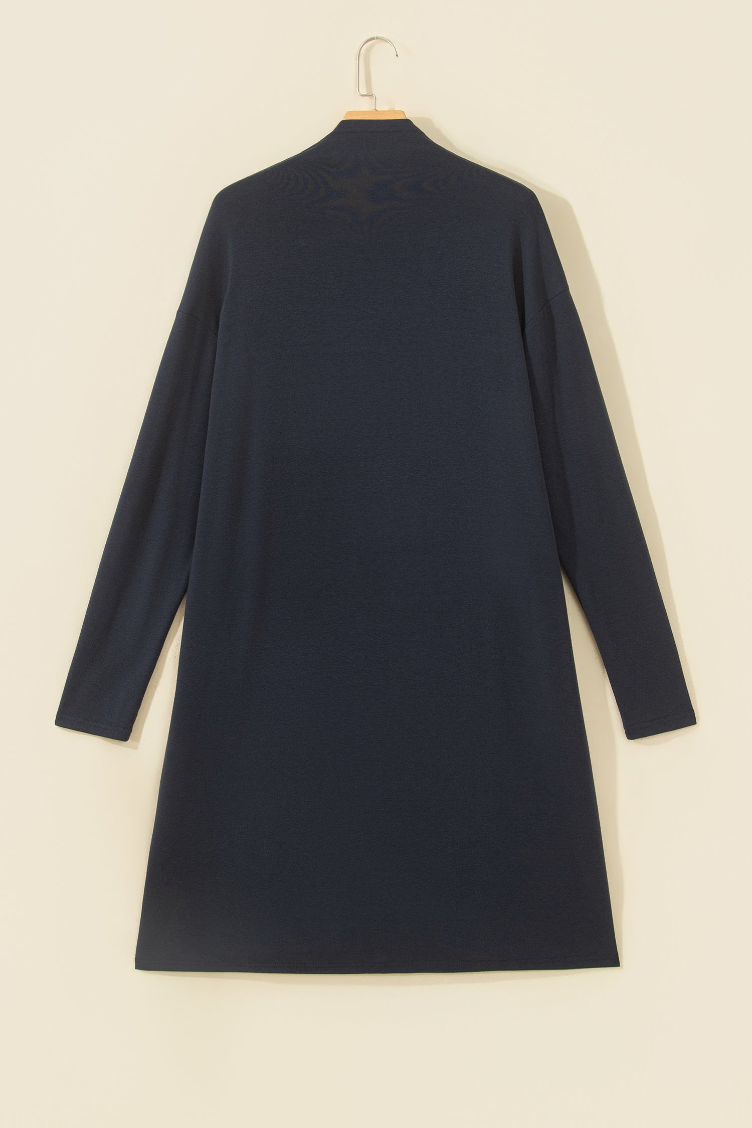 A dark navy blue long-sleeve turtleneck dress or cardigan 