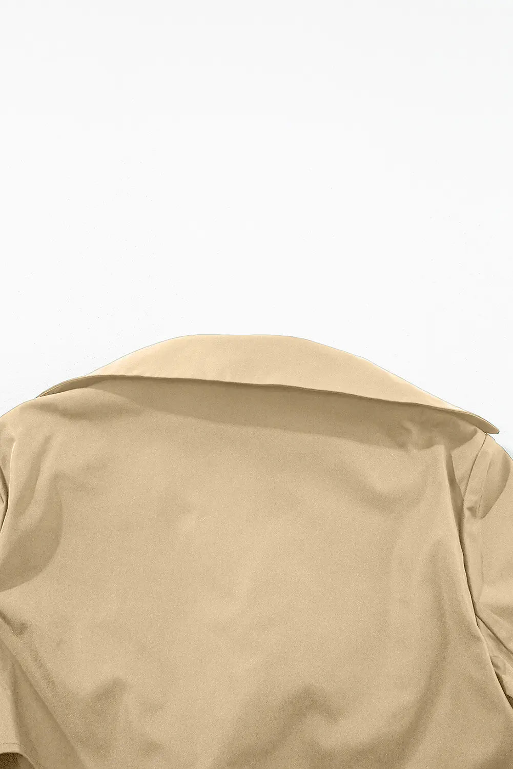 Close-up of the back of a beige trench coat against a plain white background.