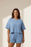 Woman wearing a blue outfit on a beige background