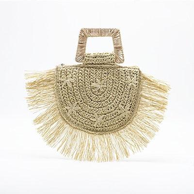 Beige woven handbag with fringe details on a white background