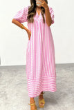 A woman wearing a pink and white vertically striped midi dress with puff sleeves and a V-neckline, paired with gold sandals and bracelets, taking a mirror selfie.